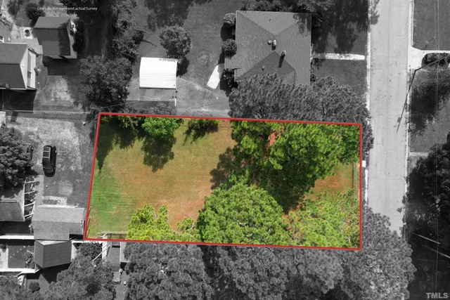 an aerial view of a house with a yard and lake view