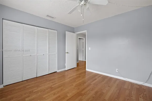 a view of an empty room with wooden floor