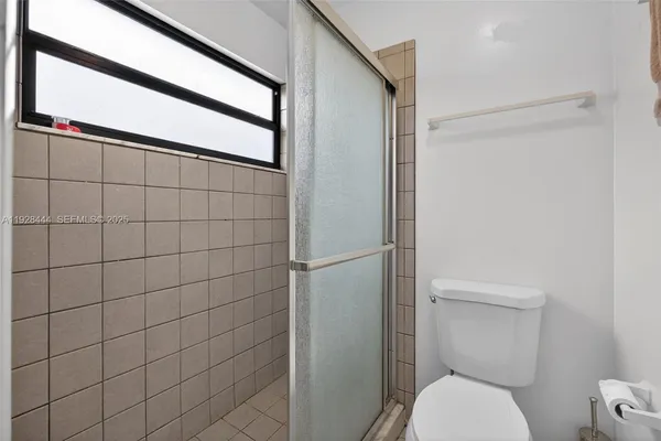 a bathroom with a toilet and a shower