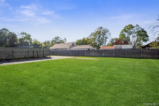 a view of yard with swimming pool and green space