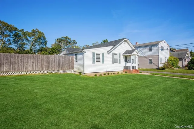 a front view of a house with a garden and yard