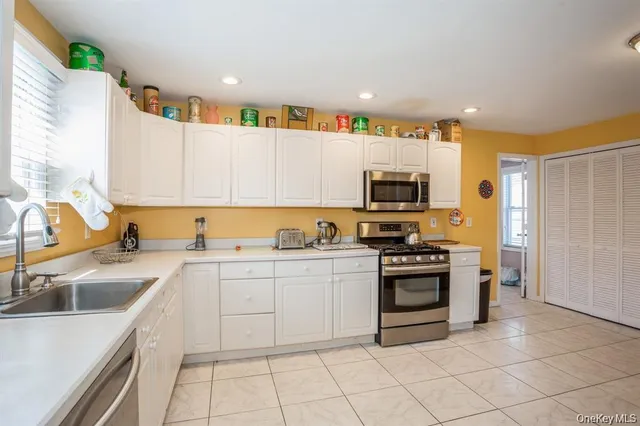 a kitchen with a sink stove and microwave