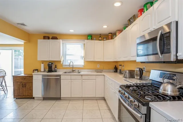 a kitchen with a stove a sink and a microwave
