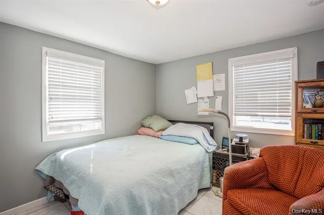 a bedroom with a bed couch and window