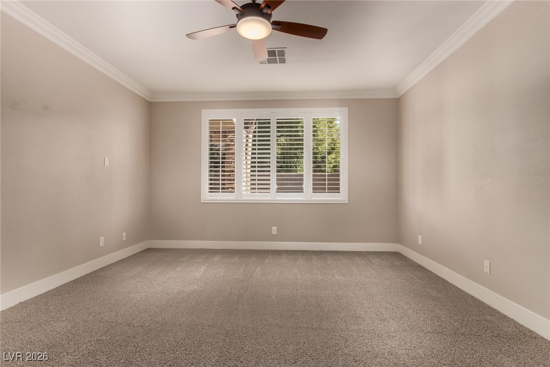 264 Pointe Ranier Avenue Henderson, NV 89012 - Photo 14 of 47 Carpeted spare room featuring crown molding and ceiling fan