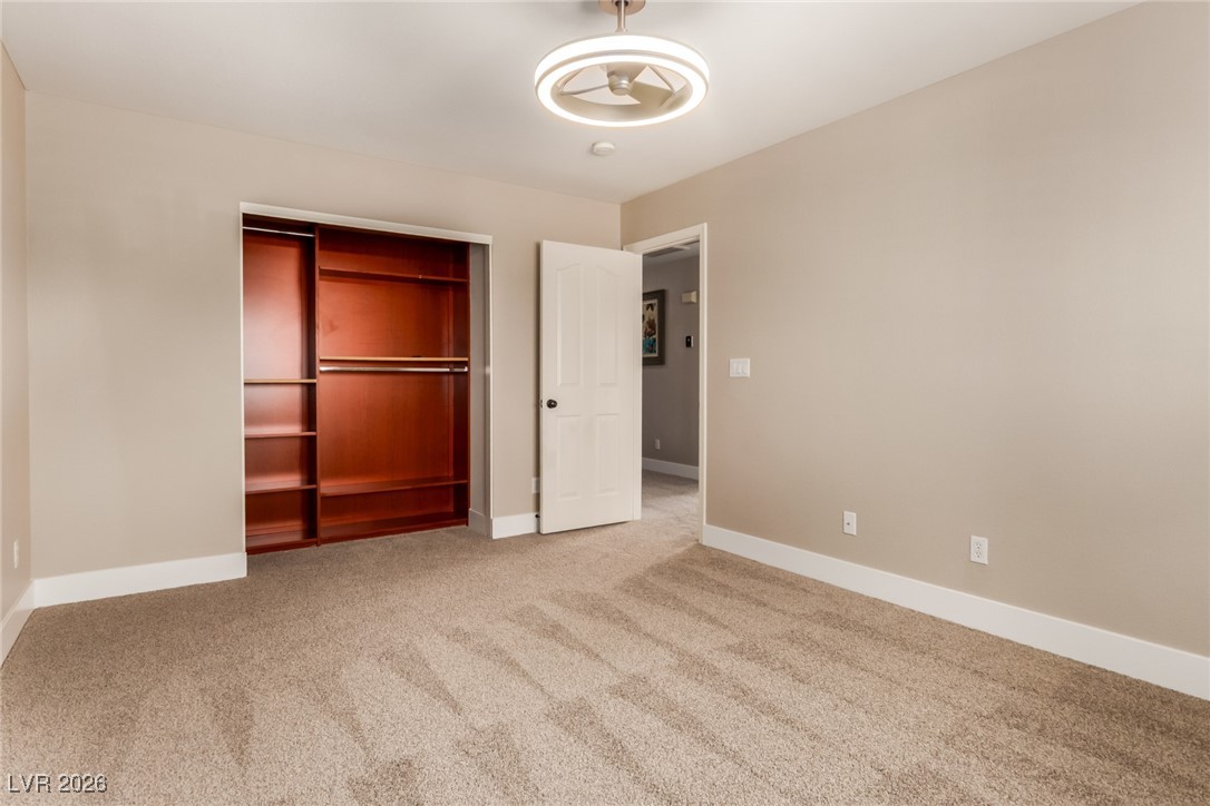 264 Pointe Ranier Avenue Henderson, NV 89012 - Photo 27 of 47 Unfurnished bedroom featuring a closet and carpet