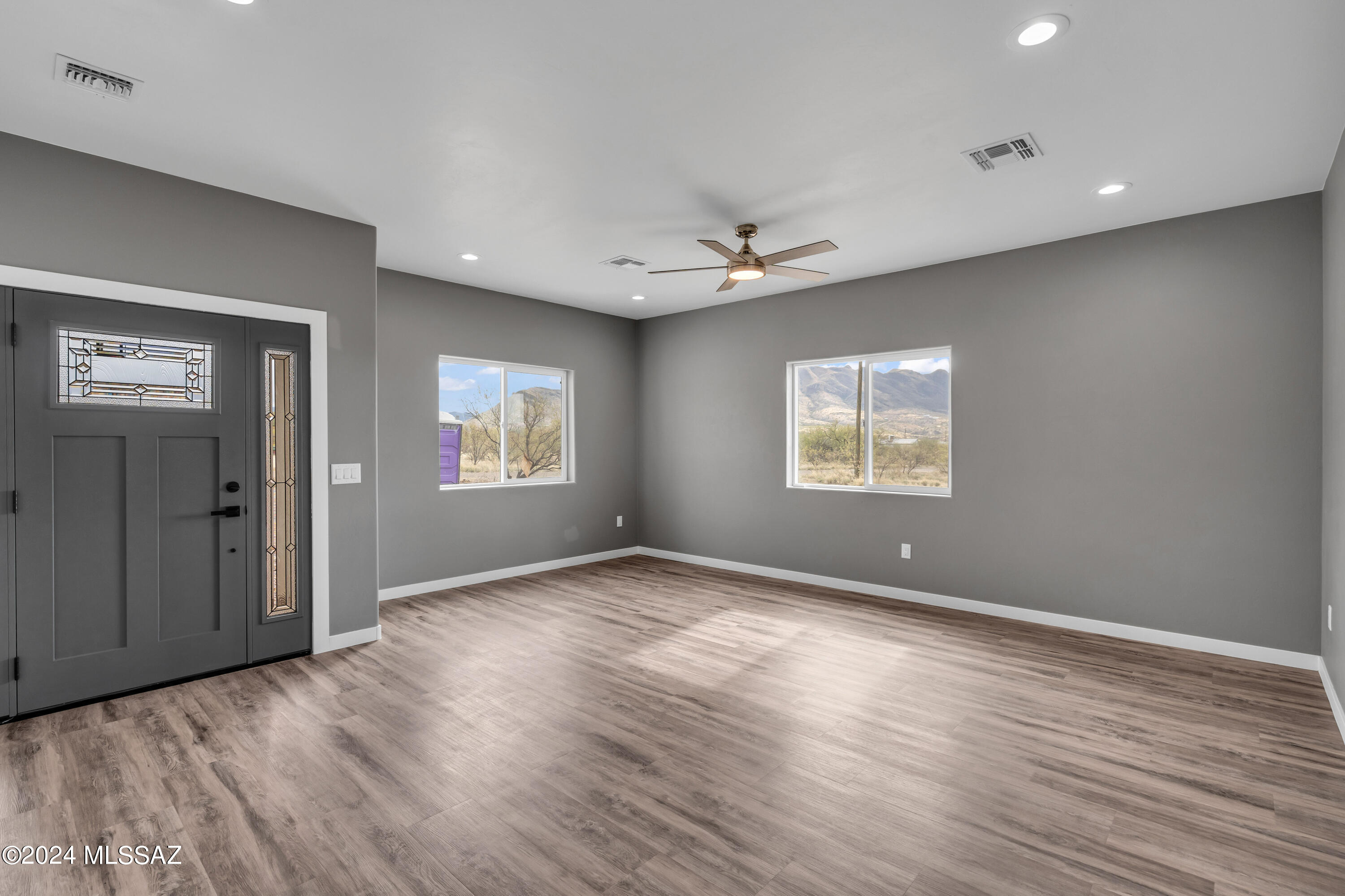 1840 La Paz Court Rio Rico, AZ 85648 - Photo 14 of 25 a view of an empty room with a window and wooden floor