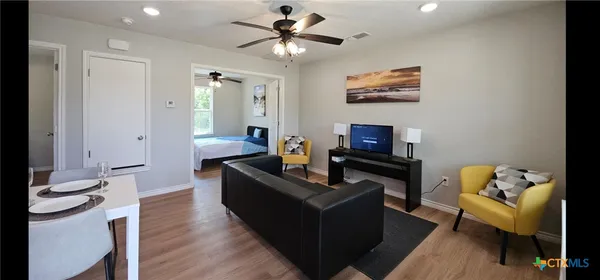 a living room with furniture and a flat screen tv