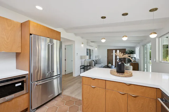a kitchen with stainless steel appliances granite countertop a refrigerator and a sink