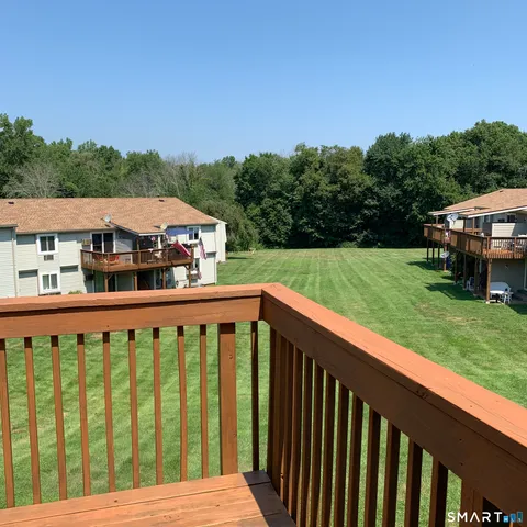a view of a wooden deck and a yard