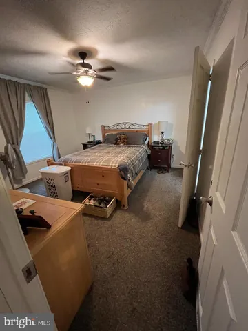 a bed room with a bed furniture and a large mirror