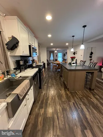 a kitchen with stainless steel appliances granite countertop a lot of counter space