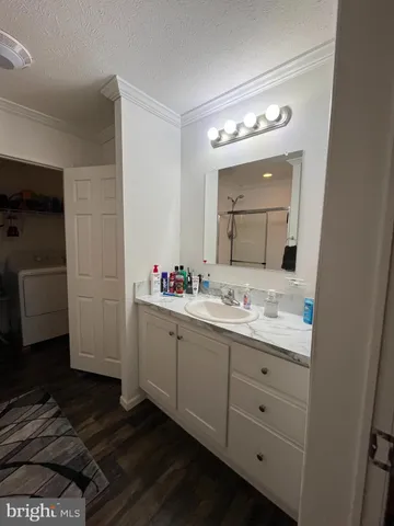a bathroom with a granite countertop sink vanity and mirror