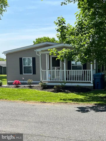 a front view of a house with a garden and deck