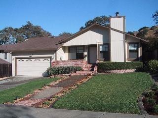 55 Sanchez Way Novato, CA 94947 - Photo 1 of 8 a front view of a house with a yard and garage