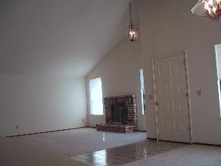 55 Sanchez Way Novato, CA 94947 - Photo 3 of 8 an empty room with fireplace and windows
