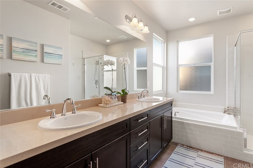 2189 Miner Street Costa Mesa, CA 92627 - Photo 15 of 21 a bathroom with a double vanity sink a mirror and a bathtub