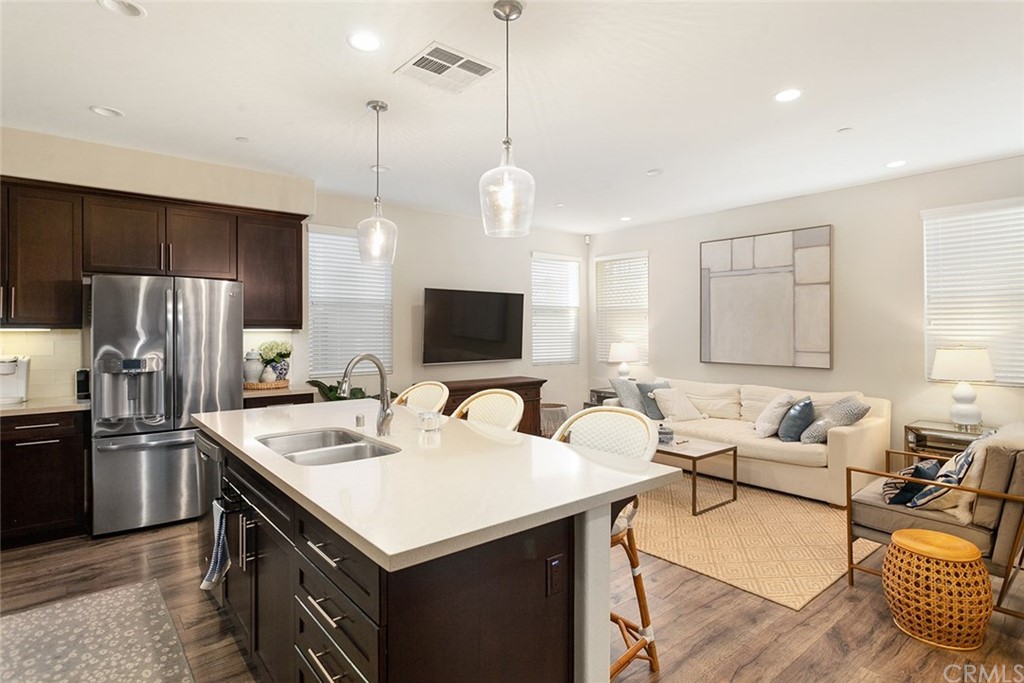 2189 Miner Street Costa Mesa, CA 92627 - Photo 6 of 21 a kitchen with a sink a counter top space stainless steel appliances and cabinets