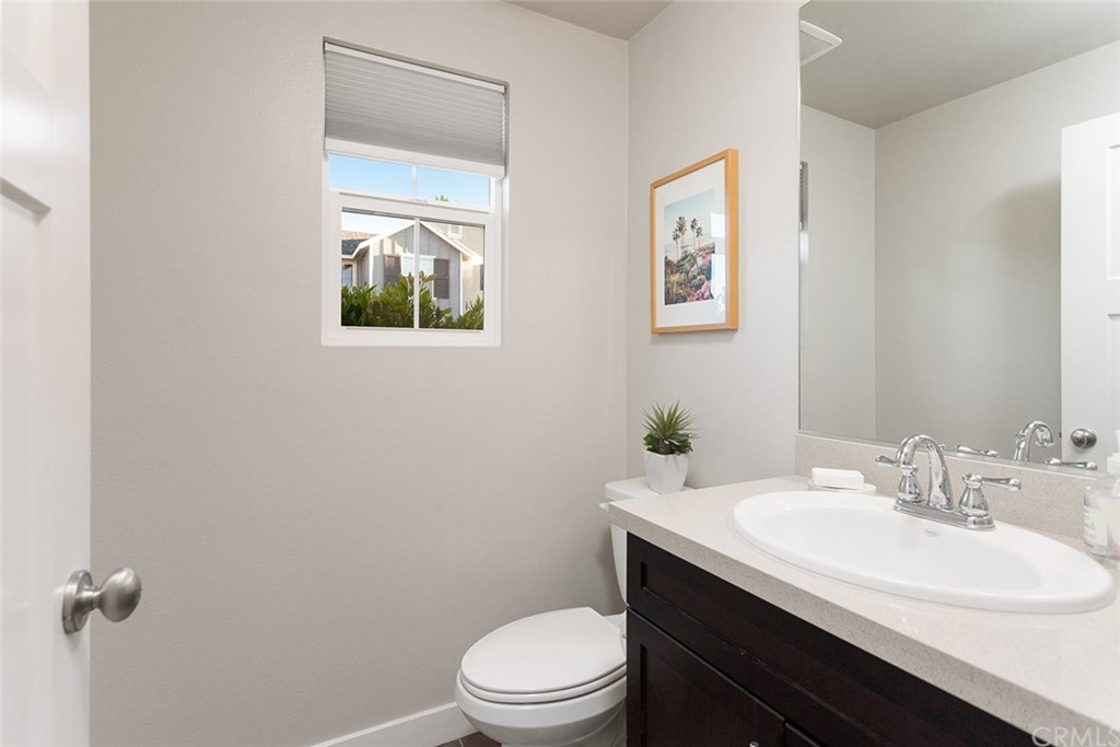 2189 Miner Street Costa Mesa, CA 92627 - Photo 10 of 21 a bathroom with a sink a toilet and a mirror