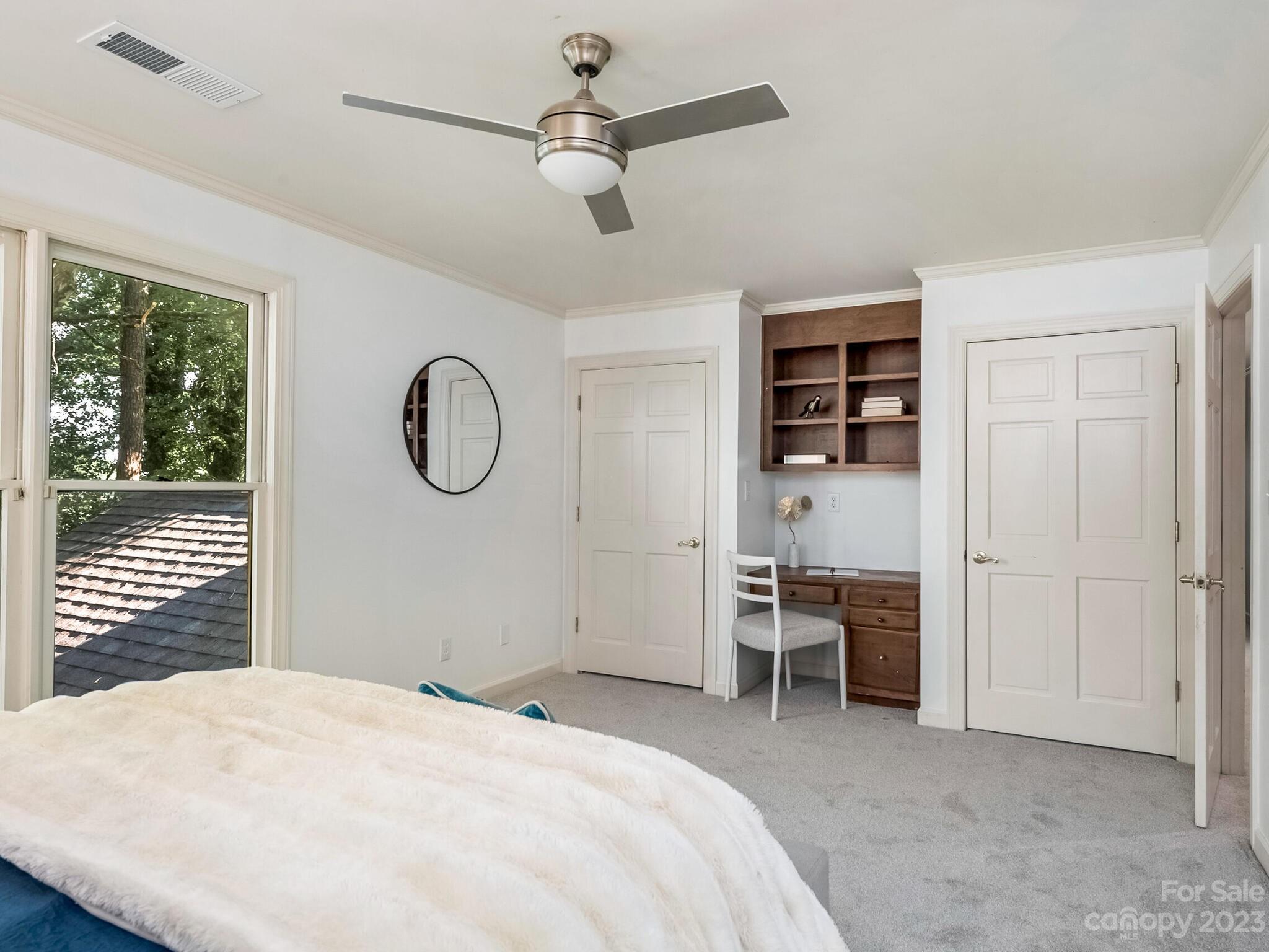 4615 Nora's Path Road Charlotte, NC 28226 - Photo 27 of 34 a bedroom with a bed and a chandelier