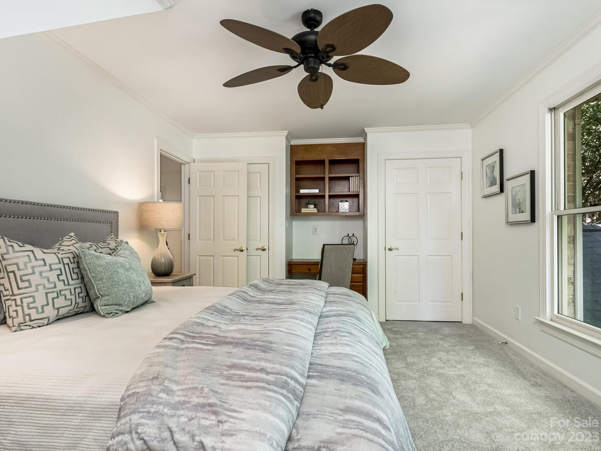 4615 Nora's Path Road Charlotte, NC 28226 - Photo 29 of 34 a bedroom with a bed and a chandelier