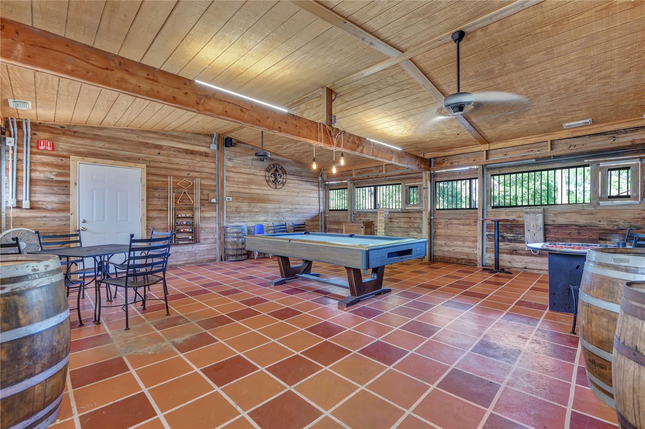 215 Reidland Road Crosby, TX 77532 - Photo 36 of 37 a living room with a table tennis table and chairs