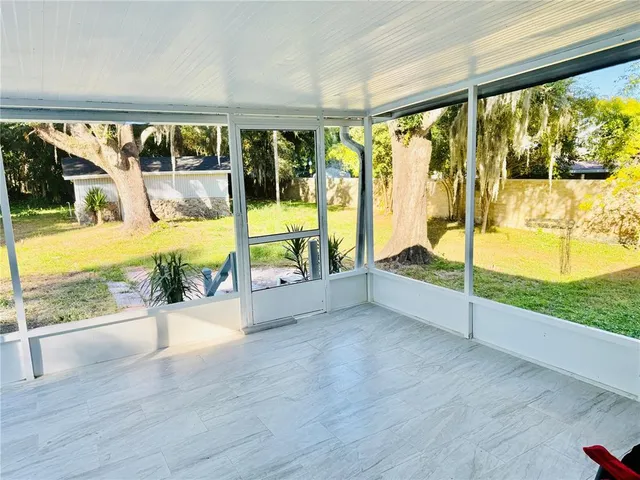 a view of a swimming pool with a porch and furniture