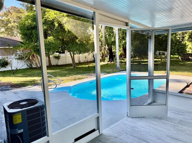 a view of a house with swimming pool and yard
