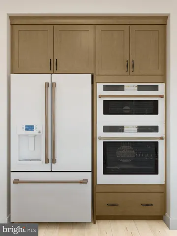 a stove top oven sitting inside of a kitchen