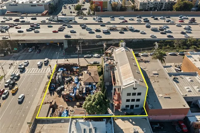 an aerial view of a swimming pool with outdoor seating