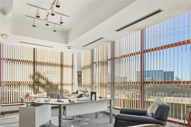 a living room with furniture and large windows