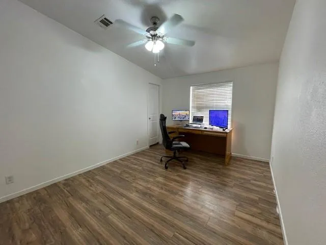 a living room with furniture and a ceiling fan