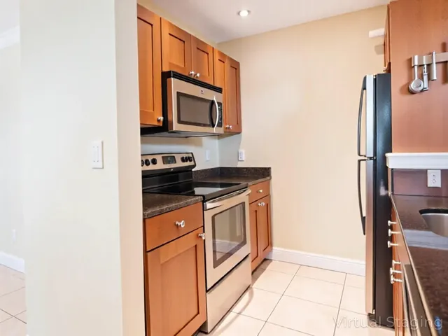 a kitchen with stainless steel appliances a stove microwave and sink