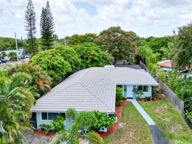 a aerial view of a house next to a yard