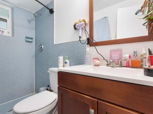 a bathroom with a sink a toilet and mirror