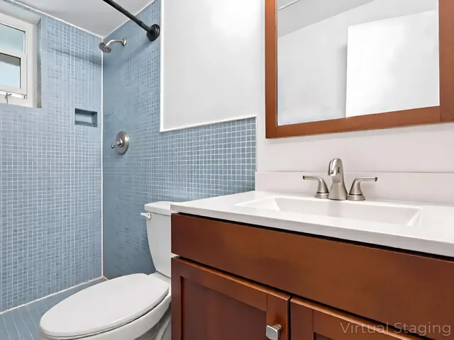 a bathroom with a sink toilet and mirror