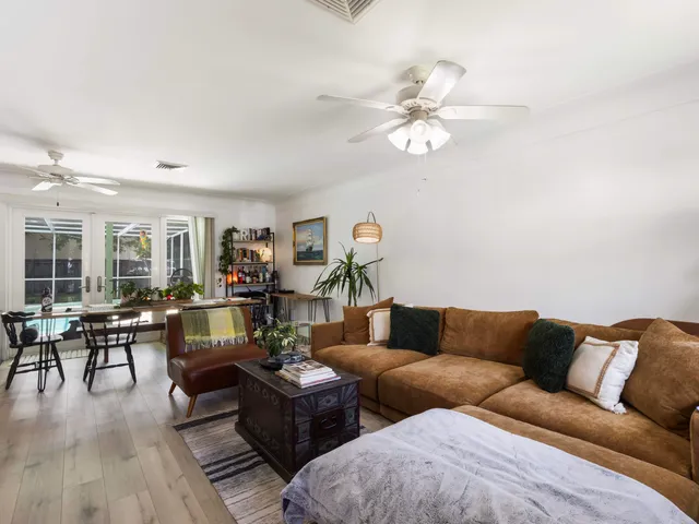 a living room with furniture wooden floor and window