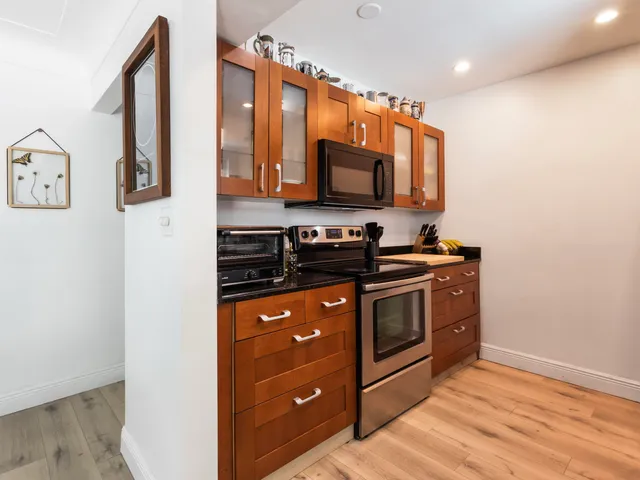 a kitchen with stainless steel appliances a stove microwave and sink