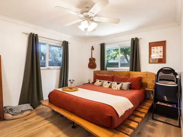 a bedroom with a large bed and a window