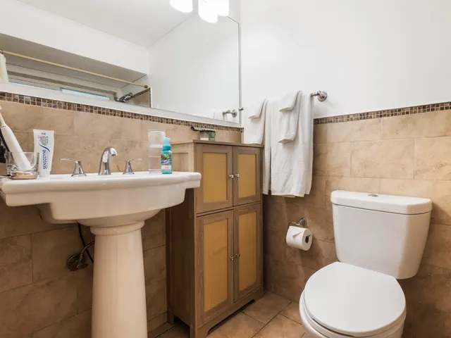 a bathroom with a sink toilet and a mirror