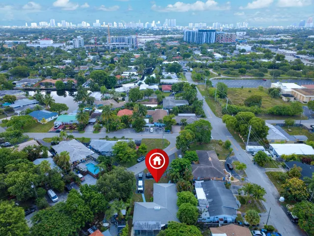 an aerial view of residential houses with outdoor space and street view