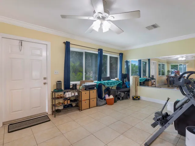 a room with gym equipment and large window