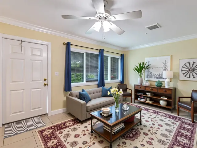a living room with furniture a rug and a chandelier