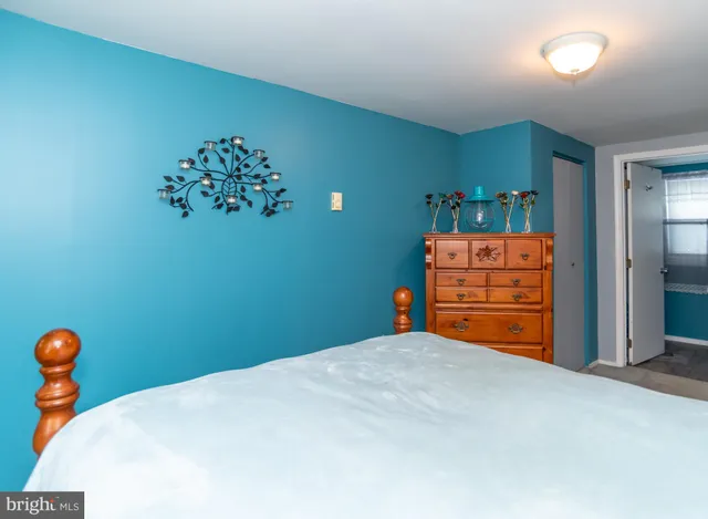 a bed room with a bed and a dresser