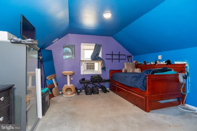 a bed room with a bed and a chair