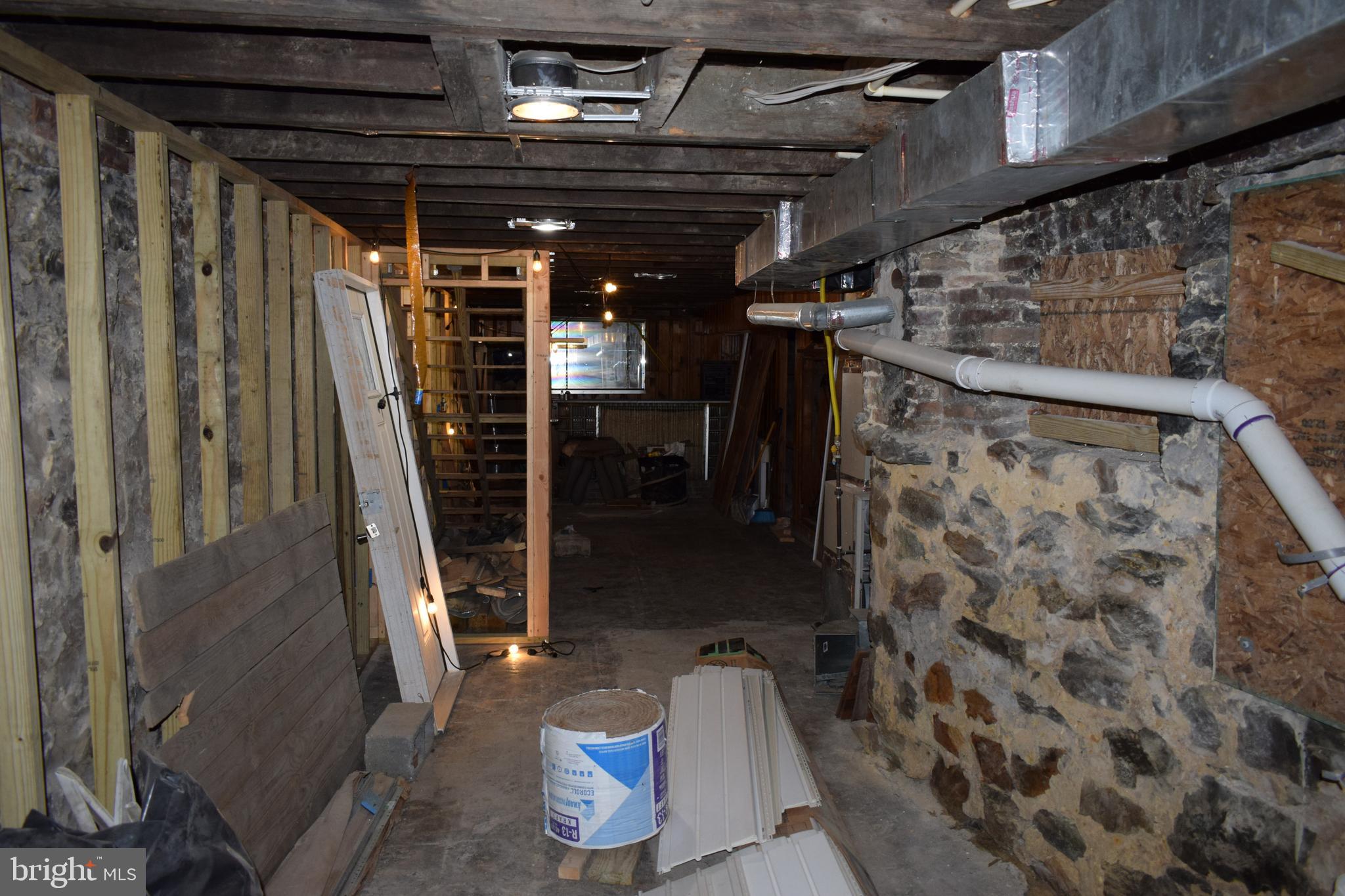 1639 Appleton Street Baltimore, MD 21217 - Photo 13 of 15 a view of water heater room with wooden floor