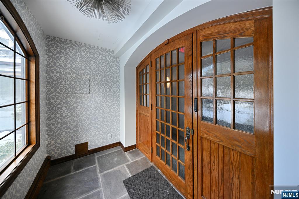 a view of a hallway with wooden floor and stairs