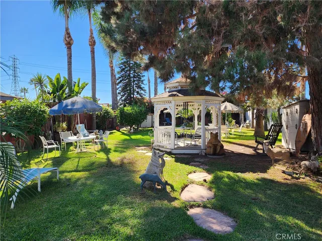 a view of a house with backyard porch and sitting area