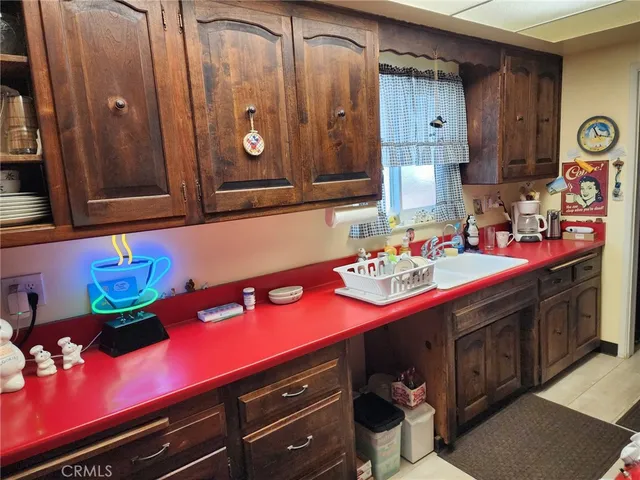 a bathroom with a sink cabinets and fan