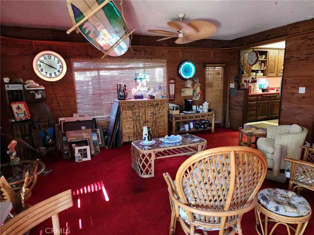 a living room with furniture a clock and a fireplace